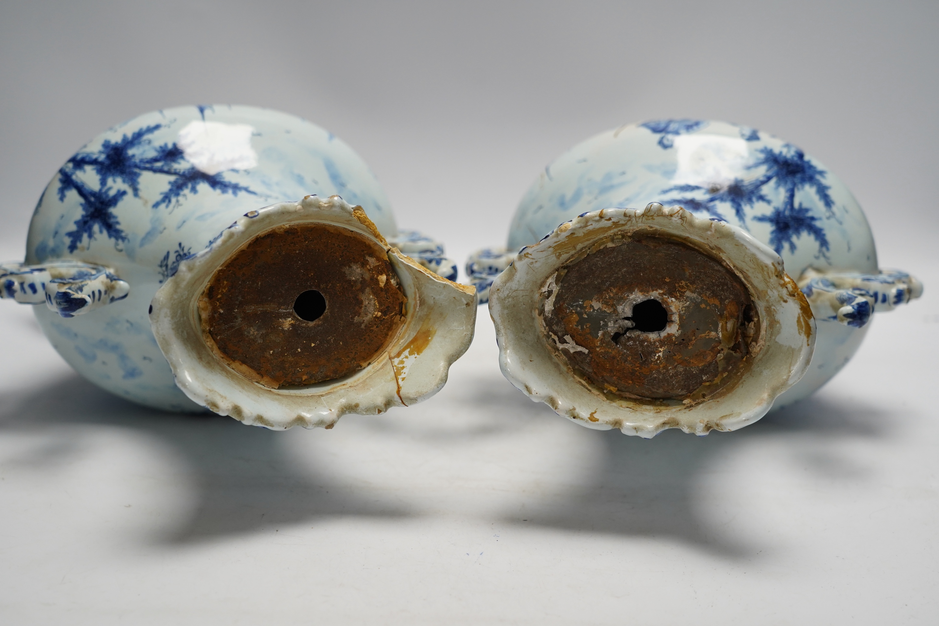 A pair of 19th century Delft blue and white vases, 35cm high. Condition - poor